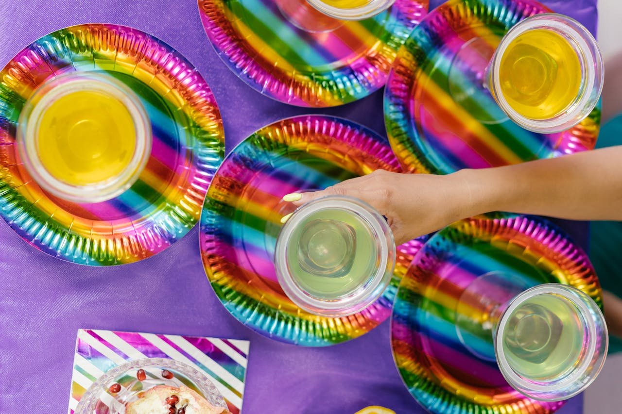 services-img A top view of colorful plates and drinks at a party, showcasing vibrant party decor.